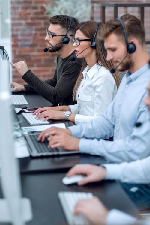 Close upcall center operators sitting at the desk business