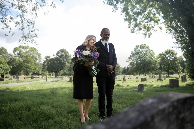 Family visiting grave of loved one